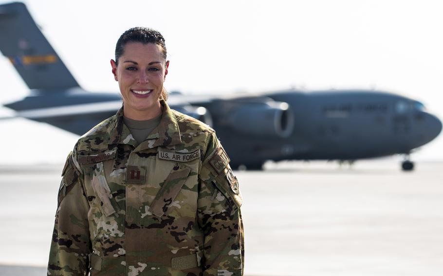 Capt. Katie Lunning, 379th Expeditionary Aeromedical Evacuation Squadron critical care air transport team registered nurse, stands in front of a C-17 Globemaster III, Oct. 13, 2021, at Al Udeid Air Base, Qatar. Lunning participated in one of the largest human airlifts in United States history by providing medical care to Afghan evacuees or service members while on board a C-17 Globemaster III. Lunning will become only the second nurse to receive the Distinguished Flying Cross on Saturday for her actions during the 2021 Afghanistan evacuation.