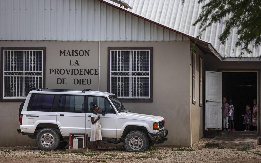 Children stand in the courtyard of the Maison La Providence de Dieu orphanage it Ganthier, Croix-des-Bouquets, Haiti, Sunday, Oct. 17, 2021, where a gang abducted 17 missionaries from a U.S.-based organization. An Ohio-based church organization says two of 17 abducted members of a missionary group have been freed in Haiti.