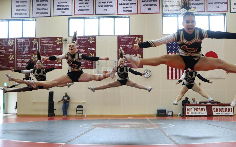 Far East Division I cheerleading champion Kadena Panthers go airborne.