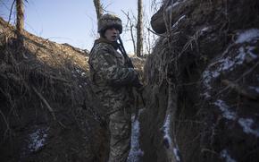A Ukrainian soldier stands in the trench on the line of separation from pro-Russian rebels, in Mariupol, Donetsk region, Ukraine, Thursday, Jan. 20, 2022. President Joe Biden has warned Russia's Vladimir Putin that the U.S. could impose new sanctions against Russia if it takes further military action against Ukraine. U.S. Secretary of State Antony Blinken is warning of a unified, "swift, severe" response from the United States and its allies if Russia sends any military forces into Ukraine. (AP Photo/Andriy Dubchak)