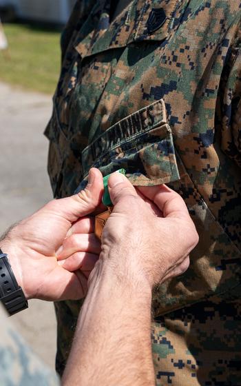 U.S. Marine Corps Gunnery Sgt. Benjamin Frazier receives the Navy and Marine Corps Commendation Medal at Naval Air Station Dam Neck, Va., Thursday, March 21, 2024. 