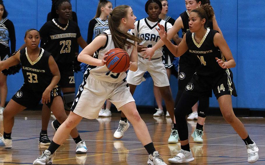 Osan’s Anne Mountcastle looks for help as she’s surrounded by Humphreys Black defenders Jaida Brinkerhoff and Clarissa Parham.