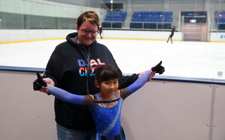 Ava Jade Gurski, 9, poses alongside her mother, Jennifer Gurski, after practice at Kose Shin Yokohama Skate Center, Oct. 20, 2022.