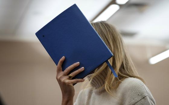 Actor Gwyneth Paltrow shields her face with a blue notebook as she exits a courtroom, Tuesday, March 21, 2023, in Park City, Utah, where she is accused in a lawsuit of crashing into a skier during a 2016 family ski vacation, leaving him with brain damage and four broken ribs. Terry Sanderson claims that the actor-turned-lifestyle influencer was cruising down the slopes so recklessly that they violently collided, leaving him on the ground as she and her entourage continued their descent down Deer Valley Resort, a skiers-only mountain known for its groomed runs, après-ski champagne yurts and posh clientele.