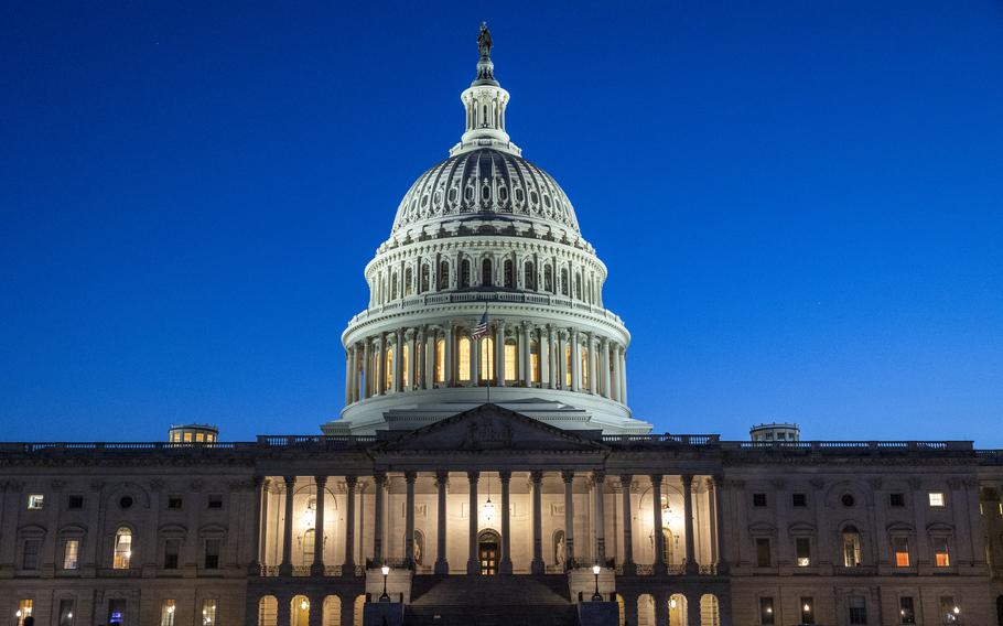 The U.S. Capitol building is illuminated with the night sky behind it.