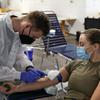 Capt. Shelby Aleksick, a nurse with the 30th Medical Brigade, donates blood in January 2022 at Rhine Ordnance Barracks in Kaiserslautern, Germany. Service members, veterans and civilians once barred from donating blood because they lived in Europe decades ago during transmission of mad cow disease may now again give blood. 