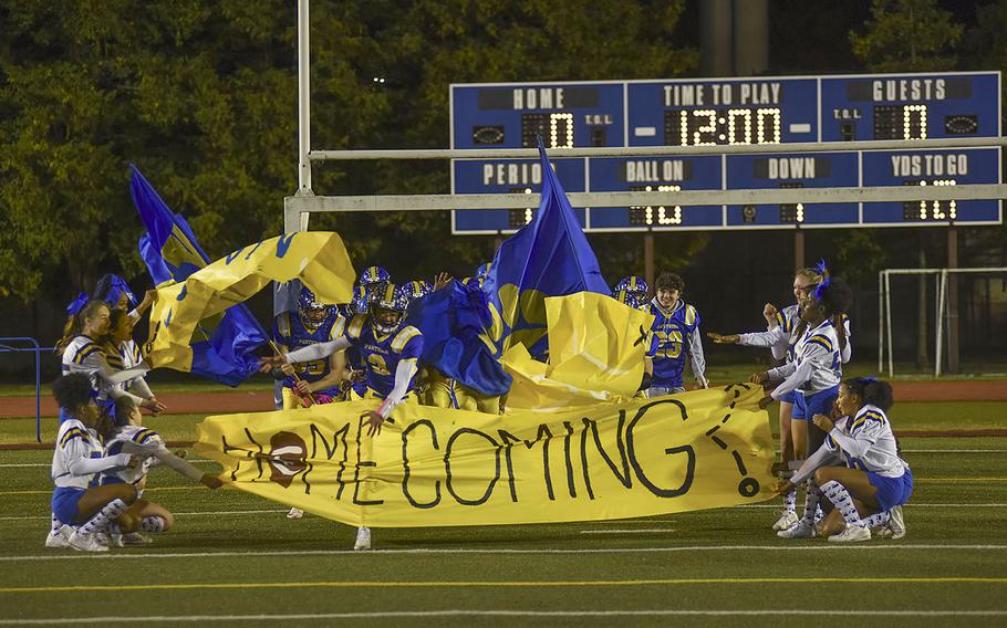 Yokota punches through a paper banner at the begining of the homecoming game between Robert D. Edgren and Yokota on Friday, Nov. 5, 2021. 