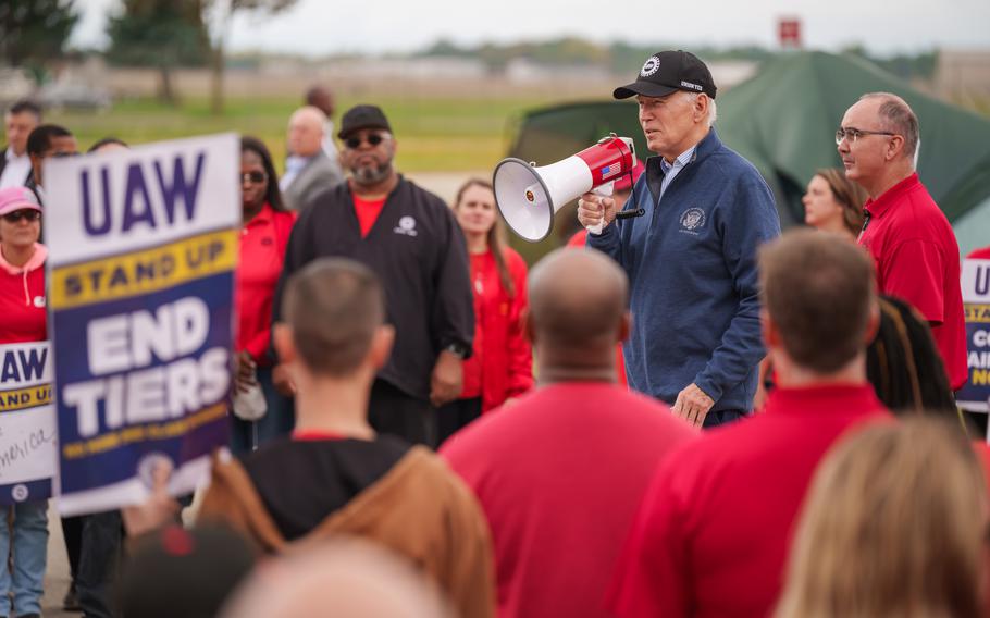 President Joe Biden addresses UAW members walking a picket line at the GM Willow Run Distribution Center, Tuesday, September 26, 2023, in Belleville, Michigan. 