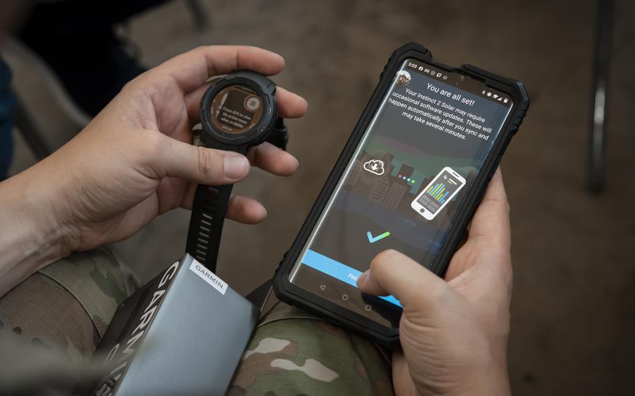 A Guardian syncs data from a wearable device to a phone during a Continuous Fitness Assessment, or CFA, study informational session hosted by an Air Force Research Laboratory team at a facility near Wright-Patterson Air Force Base, Ohio, June 8, 2023. The CFA study is a two-year voluntary effort with Guardians to assess the use of wearable fitness devices that measure physical activity.