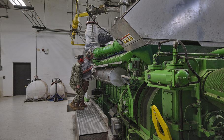 Navy Lt. Cmdr. Michael Feeney observes a landfill gas generator. The Marine Corps base in Albany, Ga., is the first in the nation to meet its net-zero goal.