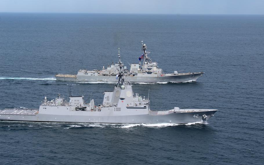 Australian Hobart-class air warfare destroyer HMAS Sydney (DDG 42) and Arleigh Burke-class destroyer USS John Finn (DDG 113) conduct a group sail in the waters off the coast of Southern California, April 1, 2021.