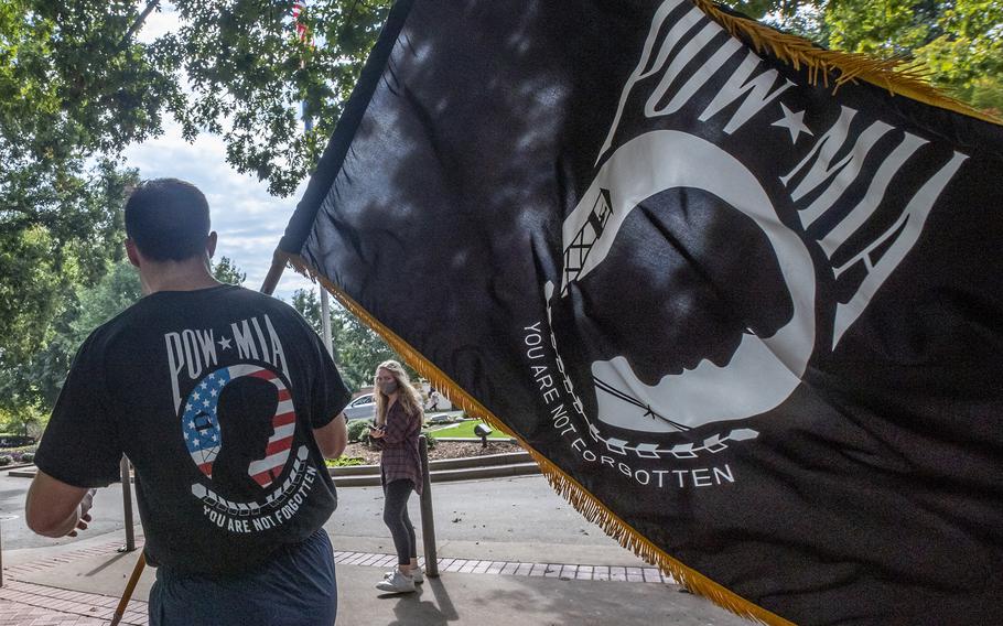 An ROTC cadet at Clemson University, S.C., carries a POW/MIA flag during an honor run Oct. 16, 2020.