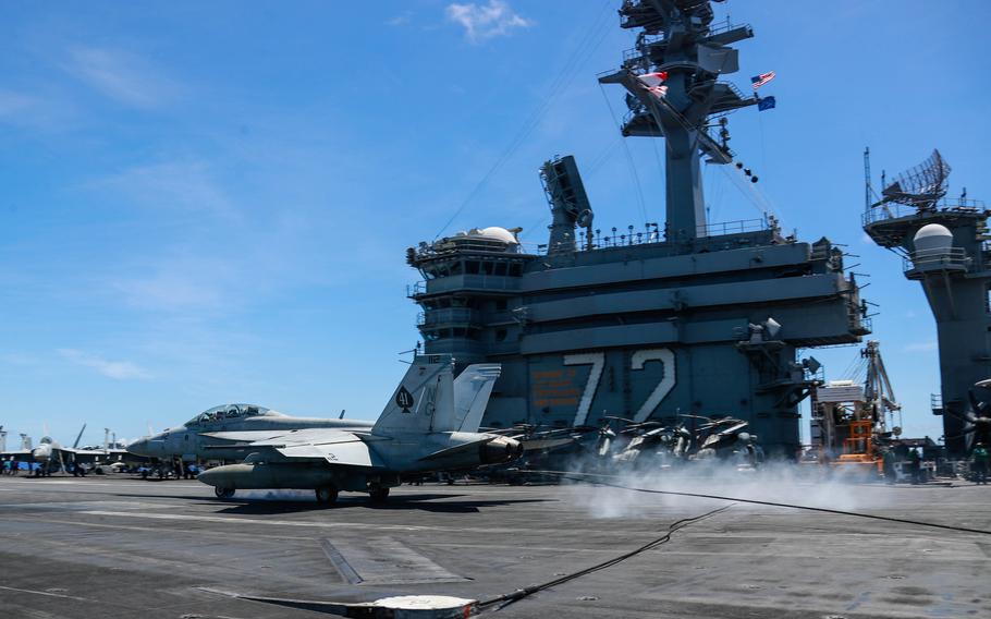 An F/A-18F Super Hornet lands aboard the USS Abraham Lincoln, Saturday, June 4, 2022. The carrier is participating in the biennial Valiant Shield exercise near Guam this week. 