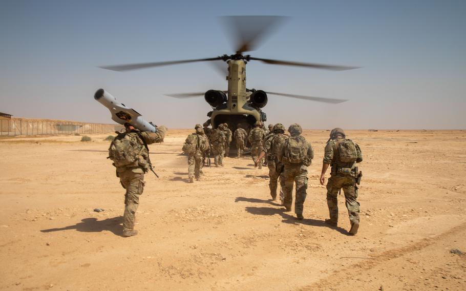 Soldiers assigned to the 37th Infantry Brigade Combat Team, 125th Infantry Regiment, 1st Battalion board a CH-47 Chinook helicopter after a live-fire exercise at al-Asad air base in Iraq in July 2023. 