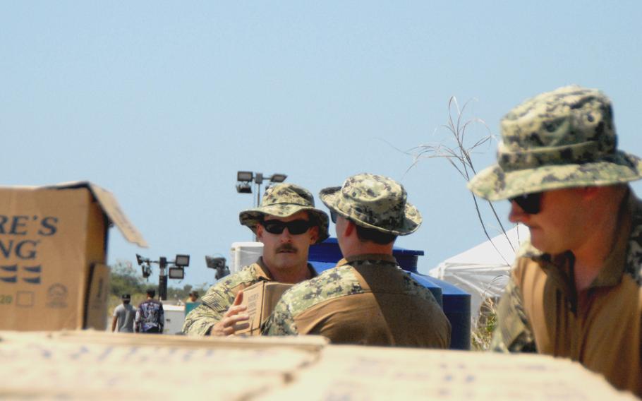 Sailors with Amphibious Construction Battalion 1, preparing for the Balikatan exercise in April, unload cases of water at Casiguran, Philippines, March 23, 2023.