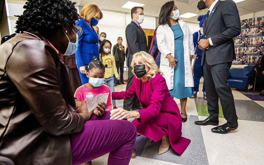 First Lady Jill Biden interacts with a family and their young children on Friday, Dec. 3, 2021, during a visit at CHOP Karabots Pediatric Care Center in West Philadelphia, Pennsylvania. 