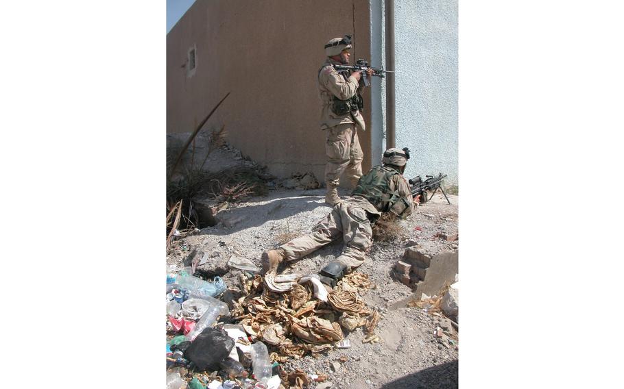 Soldiers from the 10th Mountain Division’s Company C, 4th Battalion, 31st Infantry Regiment investigate the spot of a mysterious explosion the day before at the Saba al Boor police station, a small rural town in the vicinity of Baghdad International Airport. 