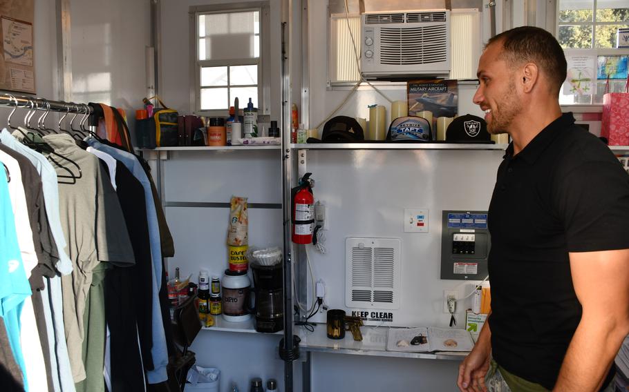 Army veteran Michael Shea, 32, gives a tour of his 8-by-8-foot shelter at the Department of Veterans Affairs campus in West Los Angeles on Feb. 23, 2022. Shea’s shelter is one of 110 tiny shelters where veterans reside while receiving social services and waiting for permanent housing.