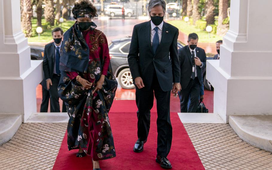 Senegalese Foreign Minister Aissata Tall Sall, left, greets US Secretary of State Antony Blinken as he arrives to meet with Senegalese President Macky Sall at the Presidential Palace in Dakar, Senegal, Saturday, Nov. 20, 2021. Blinken is on a five day trip to Kenya, Nigeria, and Senegal. (AP Photo/Andrew Harnik, Pool)