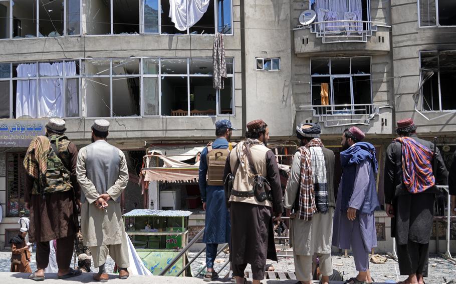 Taliban fighters gather at the site of an explosion in front of a Sikh temple in Kabul, Afghanistan, Saturday, June 18, 2022. Several explosions and gunfire ripped through a Sikh temple in Afghanistan’s capital.
