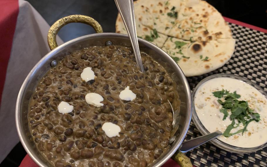Taj Mahal Ristorante Indiano in Naples, Italy offers a variety of vegetarian dishes. Clockwise from bottom left are dal makhani, garlic naan and raita. 