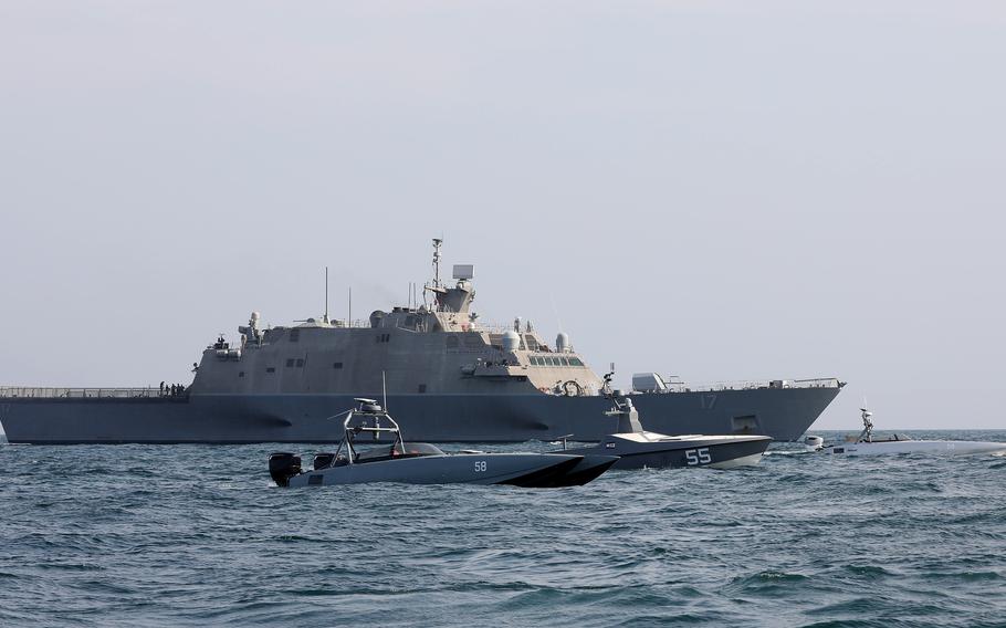 The littoral combat ship USS Indianapolis sails with two T-38 Devil Ray unmanned surface vessels and an Arabian Fox MAST-13 drone during exercise Digital Talon 2 in the Persian Gulf, Nov. 27, 2023. 