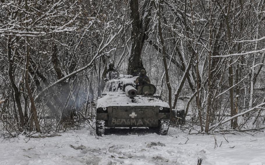 Ukrainian forces tucked within a snowy forest on a 2S1 Gvozdika Soviet-era howitzer in the Donetsk region of eastern Ukraine on Feb 14, 2023.