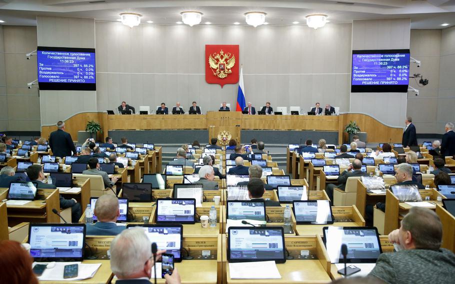 In this handout photo provided by The State Duma, The Federal Assembly of The Russian Federation, Russian lawmakers attend a session of the State Duma, the Lower House of the Russian Parliament in Moscow, Russia, Thursday, Nov. 24, 2022. Russian lawmakers have given their final approval to a bill that significantly expands restrictions on activities seen as promoting LGBTQ rights in the country. 