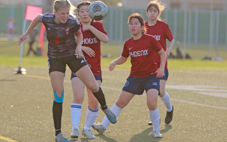 Nile C. Kinnick's Bree Withers (8) heads the ball against Seisen International during Tuesday's Kanto Plain girls soccer match. The Phoenix and Red Devils played to a scoreless draw.