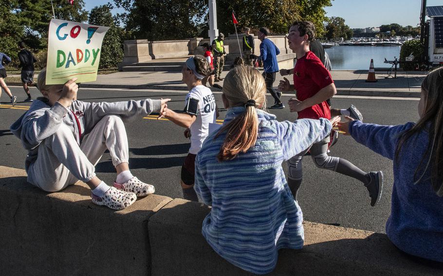 Young specators greet runners near the finish line of the Army 10-Miler on Sunday, Oct. 9, 2022, at the Pentagon.