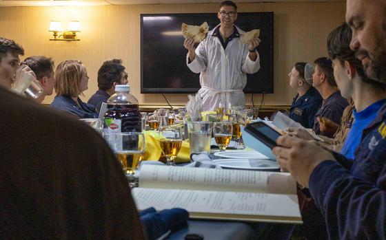 Sailors aboard the aircraft carrier USS Harry S. Truman observe Passover on April 12, 2025, with a traditional Seder, including a retelling of the story of the emancipation of Israelites from slavery in ancient Egypt. For more than a month, the Truman has conducted daily flight operations against Iran-backed Houthi militants as part of a U.S. campaign to undercut the group's ability to attack military and commercial ships in the Red Sea.