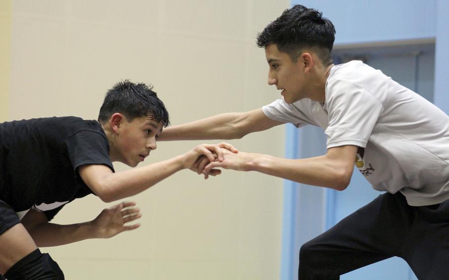 Freshman Aaron Lopez and sophomore Sebastian Campbell mix it up in Matthew C. Perry's wrestling room.