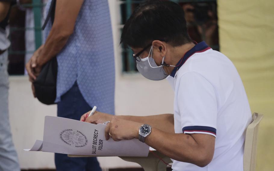 Presidential candidate Ferdinand Marcos Jr., the son of the late dictator, votes at a polling center in Batac City, Ilocos Norte, northern Philippines on Monday, May 9, 2022. 