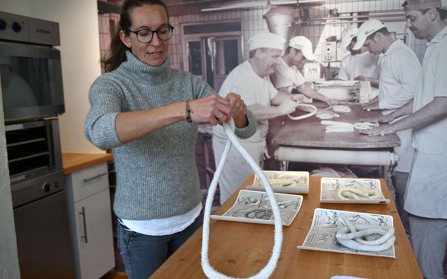 Woman makes pretzel using faux dough.