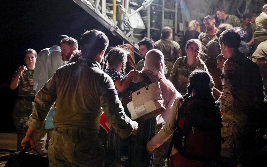 Evacuees and military personnel board an RAF aircraft bound for Cyprus from Wadi Seidna Air Base in Sudan, April 29, 2023.