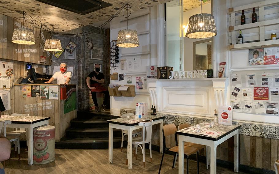 Interior seating at Johnny Take Ue includes a small dining area with a big television just inside the front door. More indoor seating is available on a second floor.  