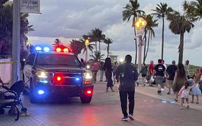FILE - Police respond to a shooting near the Hollywood Beach Broadwalk in Hollywood, Fla., Monday evening, May 29, 2023.  The FBI on Wednesday, May 31, is looking for any photos and videos that could help identify suspects in a Memorial Day shooting at a popular Florida beach promenade in which nine people were wounded, including a 1-year-old infant.(Mike Stocker/South Florida Sun-Sentinel via AP)