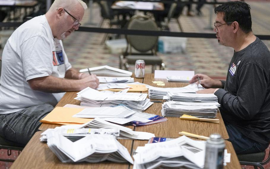 Workers count absentee ballots at the Wisconsin Center for the midterm election on Nov. 8, 2022, in Milwaukee. 