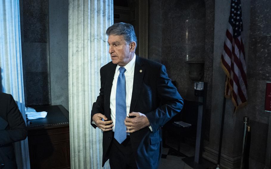 Sen. Joe Manchin III, D-W.Va., walks to a meeting on Capitol Hill on Thursday, Dec. 9, 2021, in Washington, D.C.