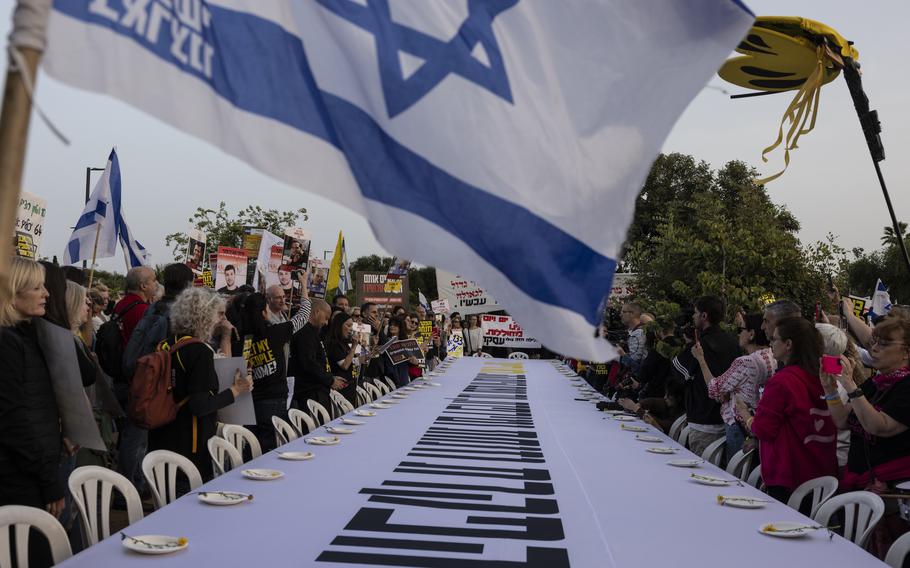 Families of Israeli hostages protest next to an empty Seder table in front of Israeli Prime Minister Benjamin Netanyahu’s home in Caesarea on Monday, the first night of Passover.