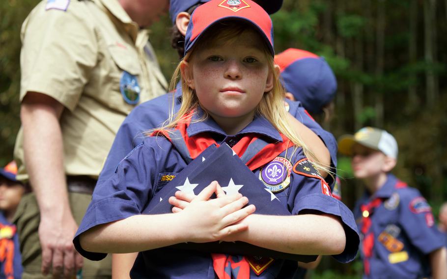 A Cub Scout with Yokosuka Pack 33 holds onto an old American flag at Ikego West Valley Campground near Yokosuka Naval Base, Japan, May 6, 2023.