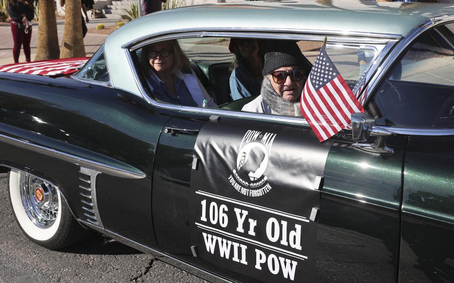 Vincent Shank, a World War II veteran and ex-POW, waves a flag before the Veterans Day parade in Las Vegas on Nov. 11, 2022. Shank died on Dec. 11. He was 106.