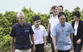 U.S. Ambassador to Japan Rahm Emanuel, left, and Ishigaki Vice Mayor Eiichiro Chinen, front right, visit a bay on Ishigaki Island in Okinawa prefecture, southern Japan Friday, May 17, 2024. Emanuel visited two southwestern Japanese islands at the forefront of tension with China's increasingly assertive actions in the regional waters. (Kyodo News via AP)