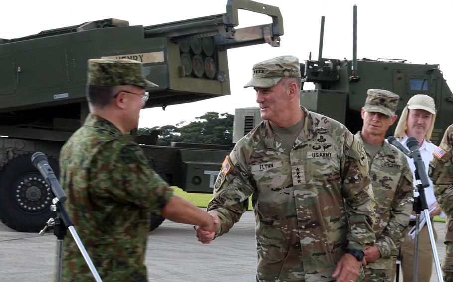 The commander of U.S. Army Pacific, Gen. Charles Flynn, thanks the head of the Japan Ground Self-Defense Force, Gen. Yoshihide Yoshida, after their news conference on Amami Oshima, Japan, Thursday, Sept. 8, 2022.