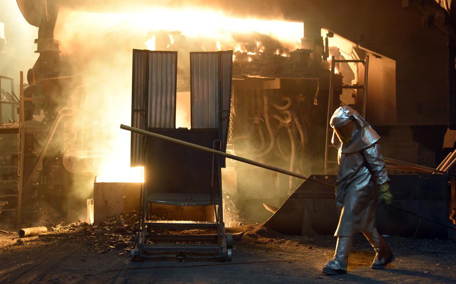 A steelworker checks the temperature of molten metal in furnace at the TMK Ipsco Koppel plant in Koppel, Pennsylvania on March 9, 2018. 