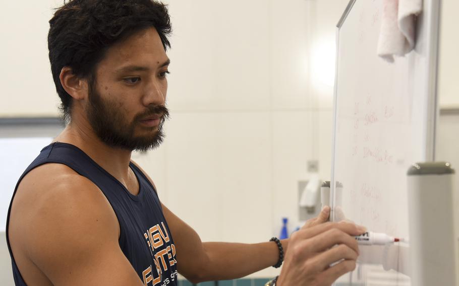 Swimming coach Sho Shimazaki write down swimming techniques for the master’s advanced course at Yokota Air Base, Japan, Friday, May 27, 2022.