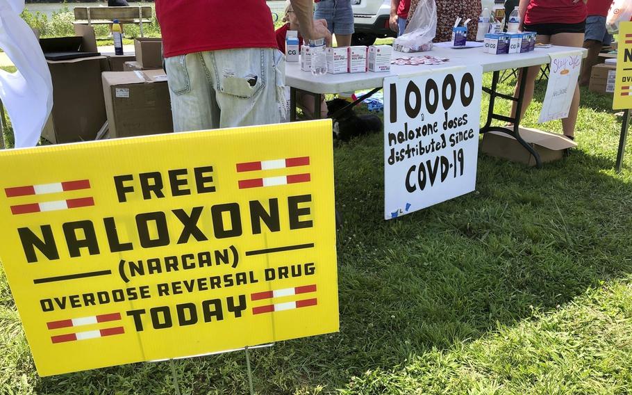 Signs advertise free Naloxone, an overdose reversal drug.