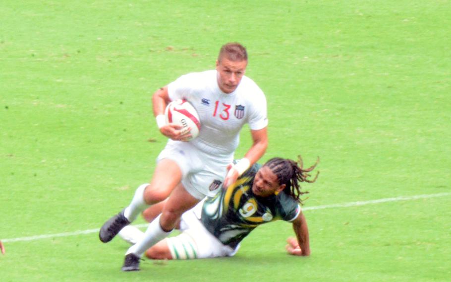 Cody Melphy, a former U.S. Army bridge engineer, breaks a tackle in the U.S. Eagles’ Olympic rugby sevens game against South Africa, Tuesday, July 27, 2021. 