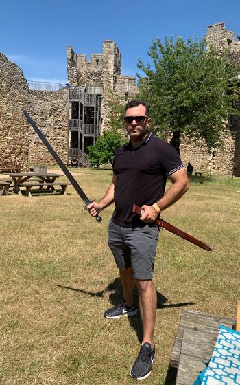 Stars and Stripes reporter Kyle Alvarez shows of his swordsmanship at Framlingham Castle, England, July 11, 2022. 