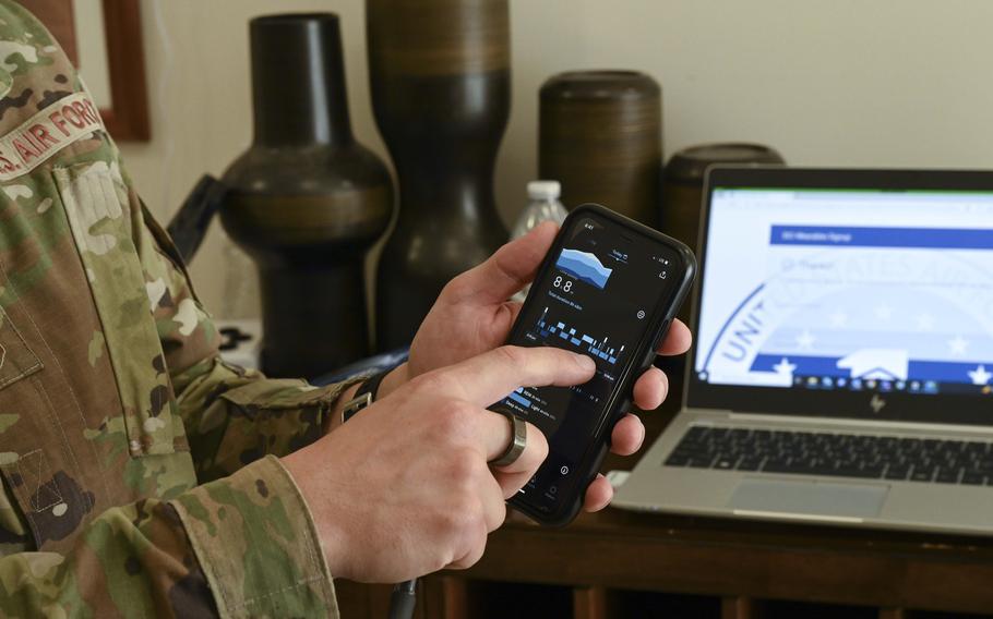 An airman shows statistics gathered from a smartwatch and ring while at an event at Joint Base Pearl Harbor-Hickam, Hawaii, April 12, 2023. The figures are part of an Air Force effort to help first sergeants monitor their stress levels and know when it's time to give themselves a break. 